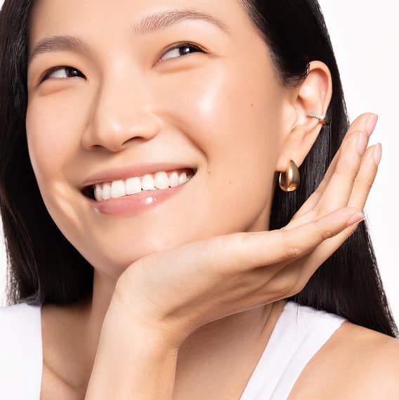 A woman applying skincare